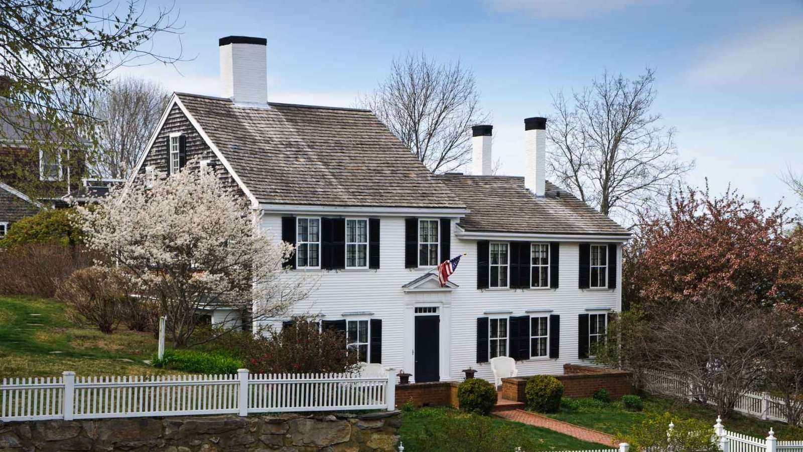 White colonial house with twin chimneys