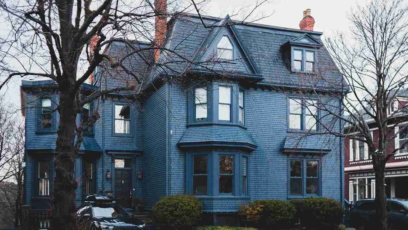 Blue Victorian home with a chimney