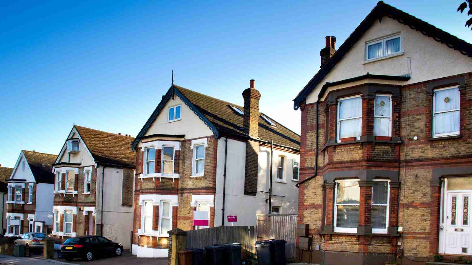 Row of brick townhouses with chimneys
