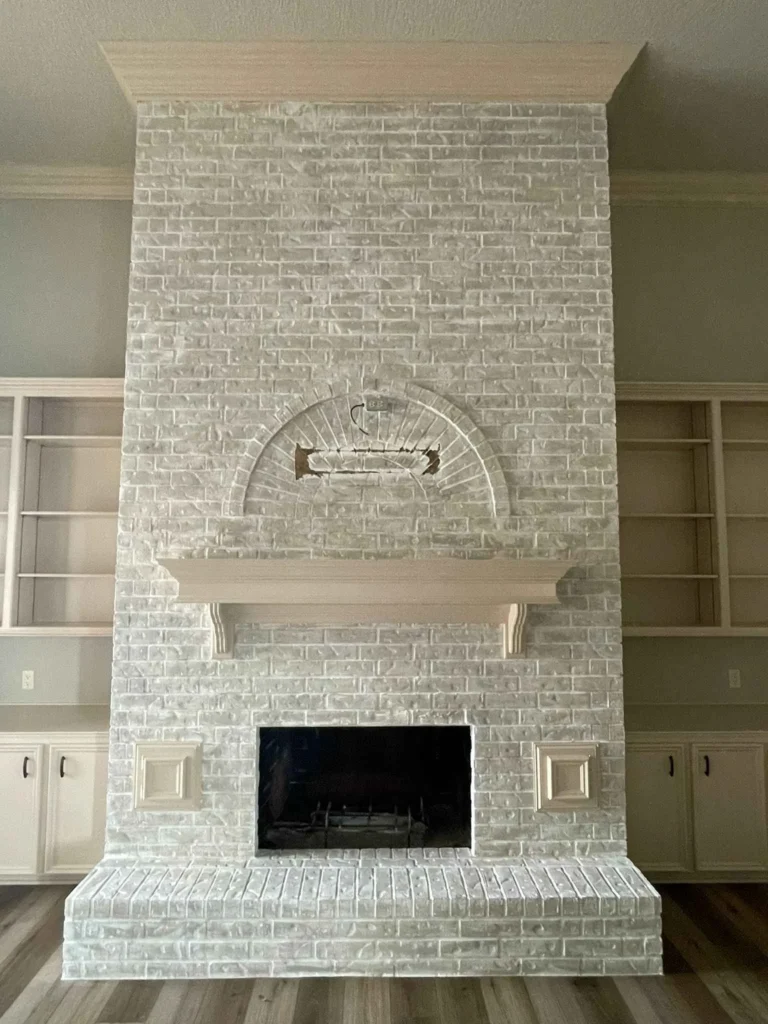 Refaced white brick fireplace with built-in shelving