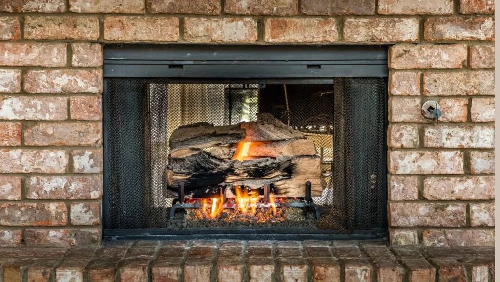 Gas log fireplace in a brick surround